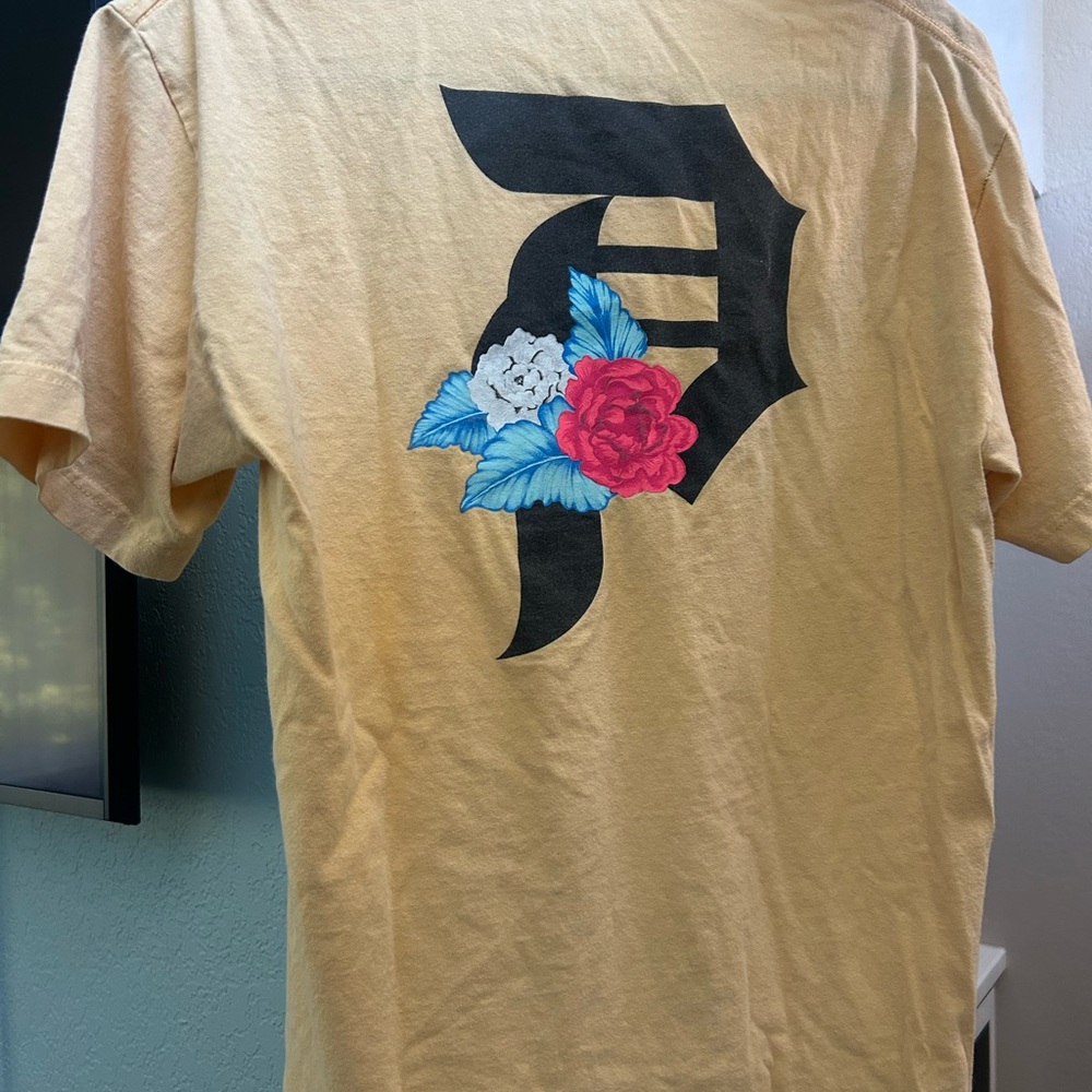 Primitive Skateboarding Yellow Shirt with Black, Blue, Red, and White Design